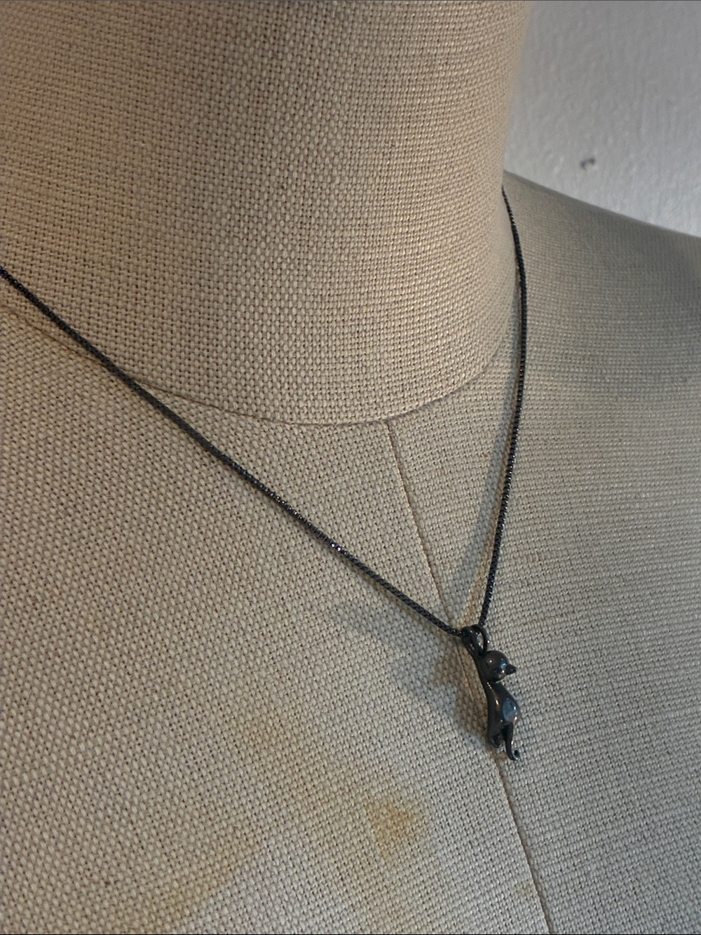 Adorable playful Kitty cat hanging from a chain necklace in black tone gunmetal